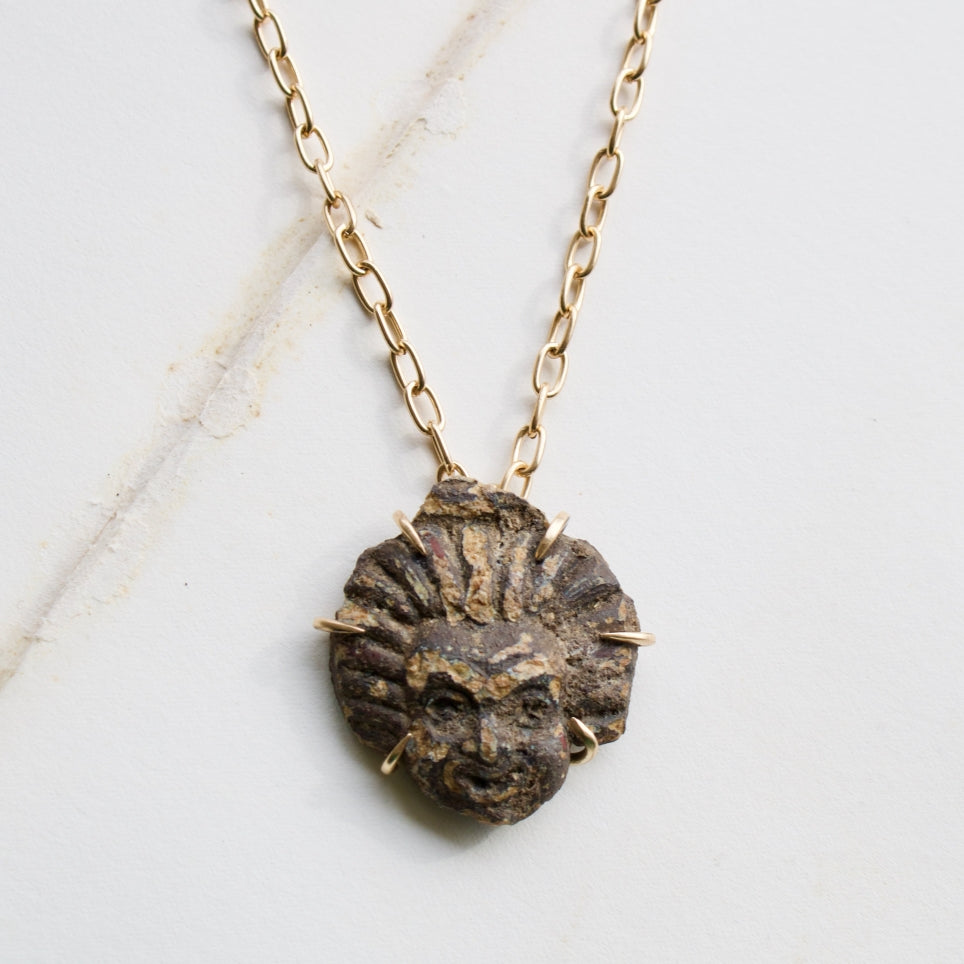 Sunburst gold pendant with a Roman carved stone